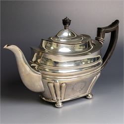 Edwardian silver teapot, of part fluted oval form upon four bun feet, with ebonised handle...