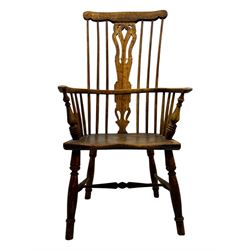 19th century provincial elm and beech Windsor armchair, shaped cresting rail over stick back with pierced and shaped splat, the dished seat on turned supports united by turned stretchers 
