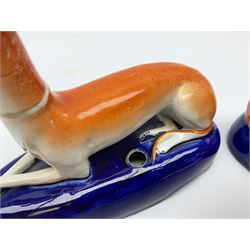 Pair of Staffordshire recumbent greyhound pen holders 