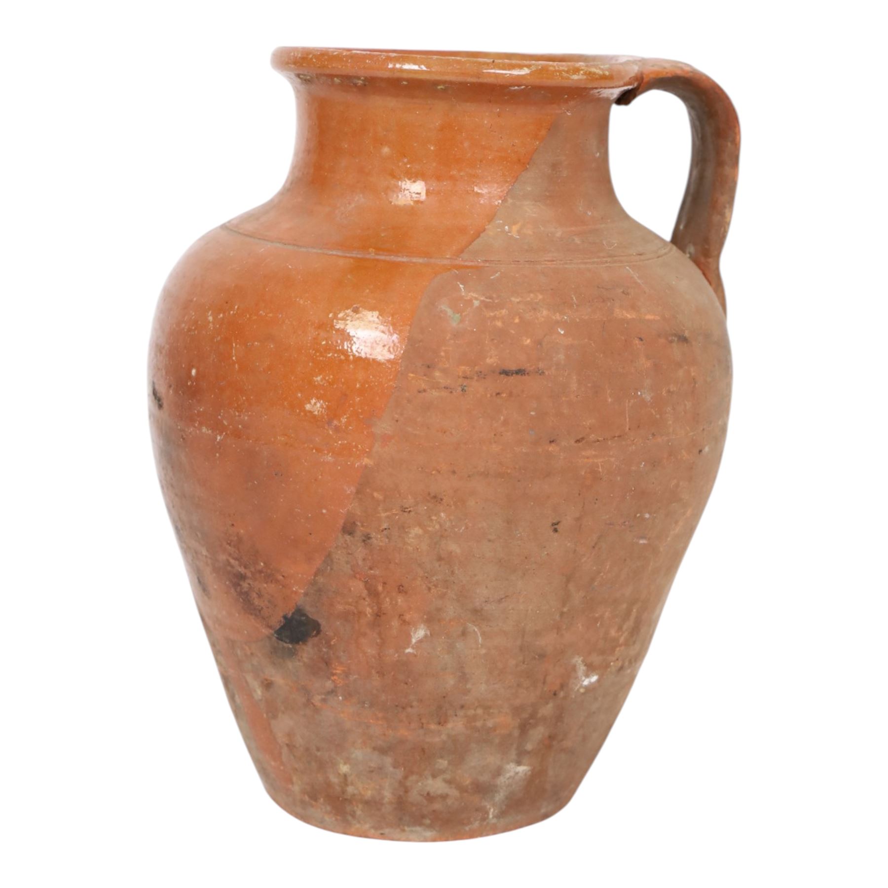 Three early 20th century Spanish part glazed terracotta storage vessels, the first example of bellied form with rounded base and twin loop handles, H24cm, the second of baluster for with close set loop handles, H30cm, and the third smaller also of baluster form with single loop handle, H24cm