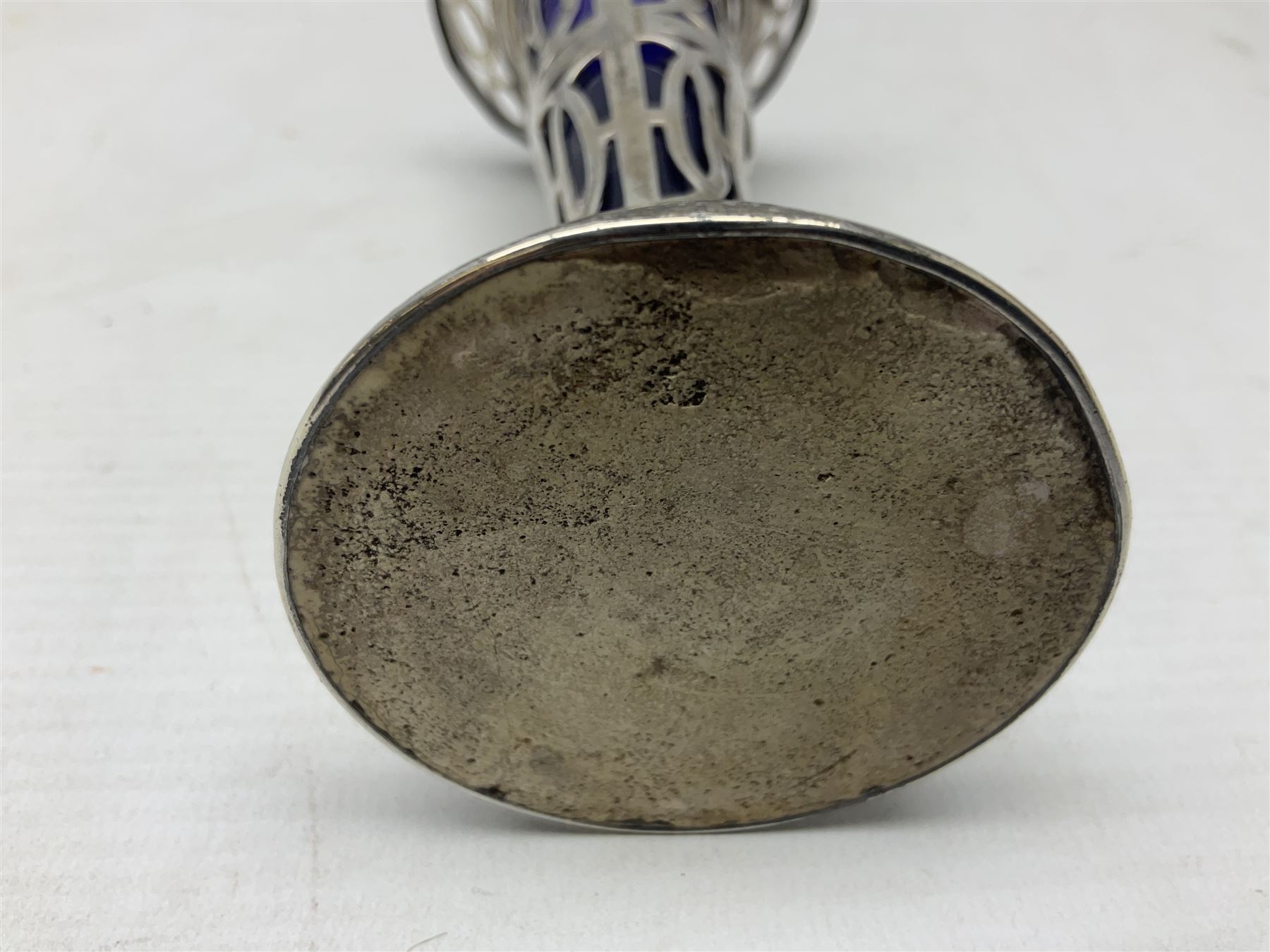 20th century silver specimen vase, of pierced trumpet form with flared rim, filled base, and blue glass liner, hallmarked Birmingham 