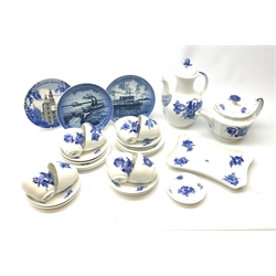 Royal Copenhagen tea wares, comprising teapot of canted form, coffee pot with bud finial, a small tray or sandwich plate, eight teacups and eight saucers, and a pin dish, all decorated with blue flowers upon a white ground, each with maker’s marks beneath, together with three further Royal Copenhagen plates. 