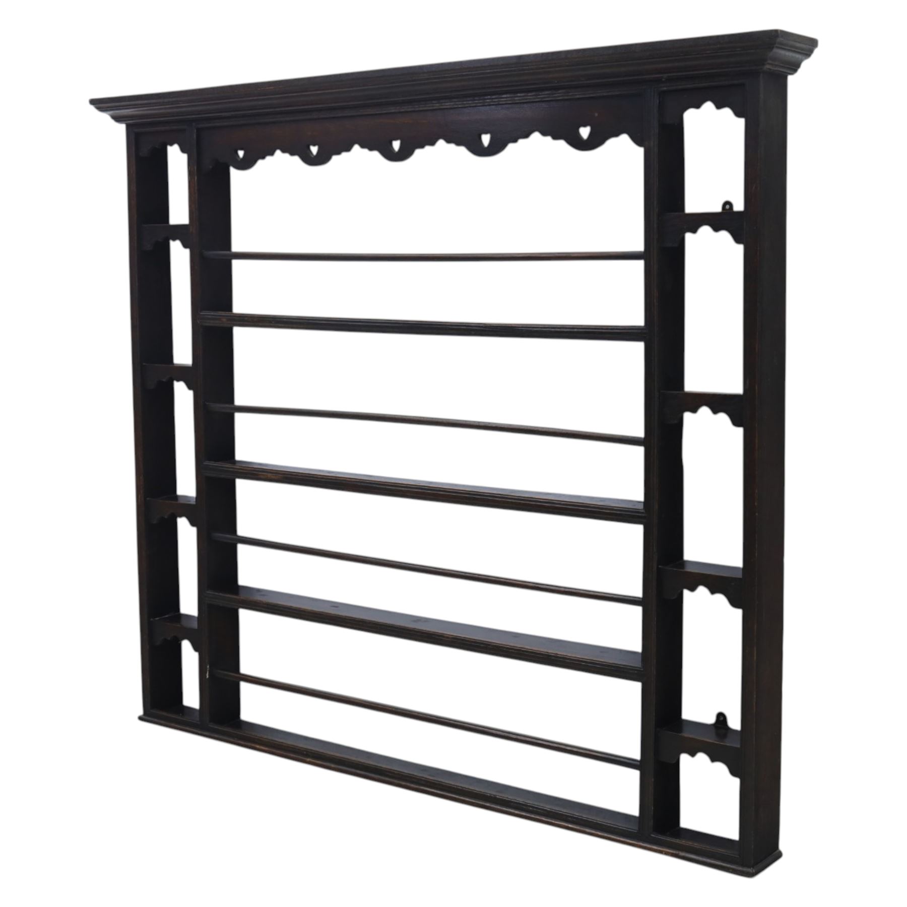 Large 18th century oak plate rack, fitted with narrow pigeon hole shelves to either side, with four central shelves and bars