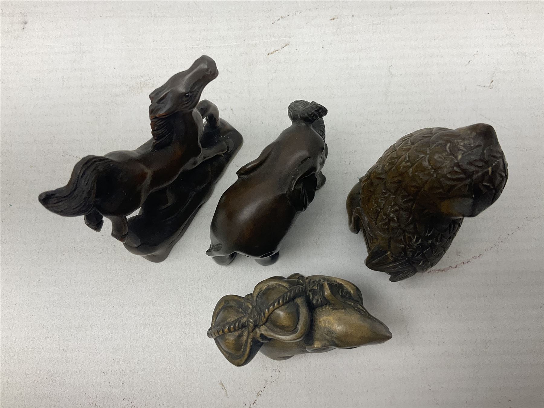 Eight netsuke, modelled as a rabbit, rat, elephant, rhino, dog, owl, penguin and horse