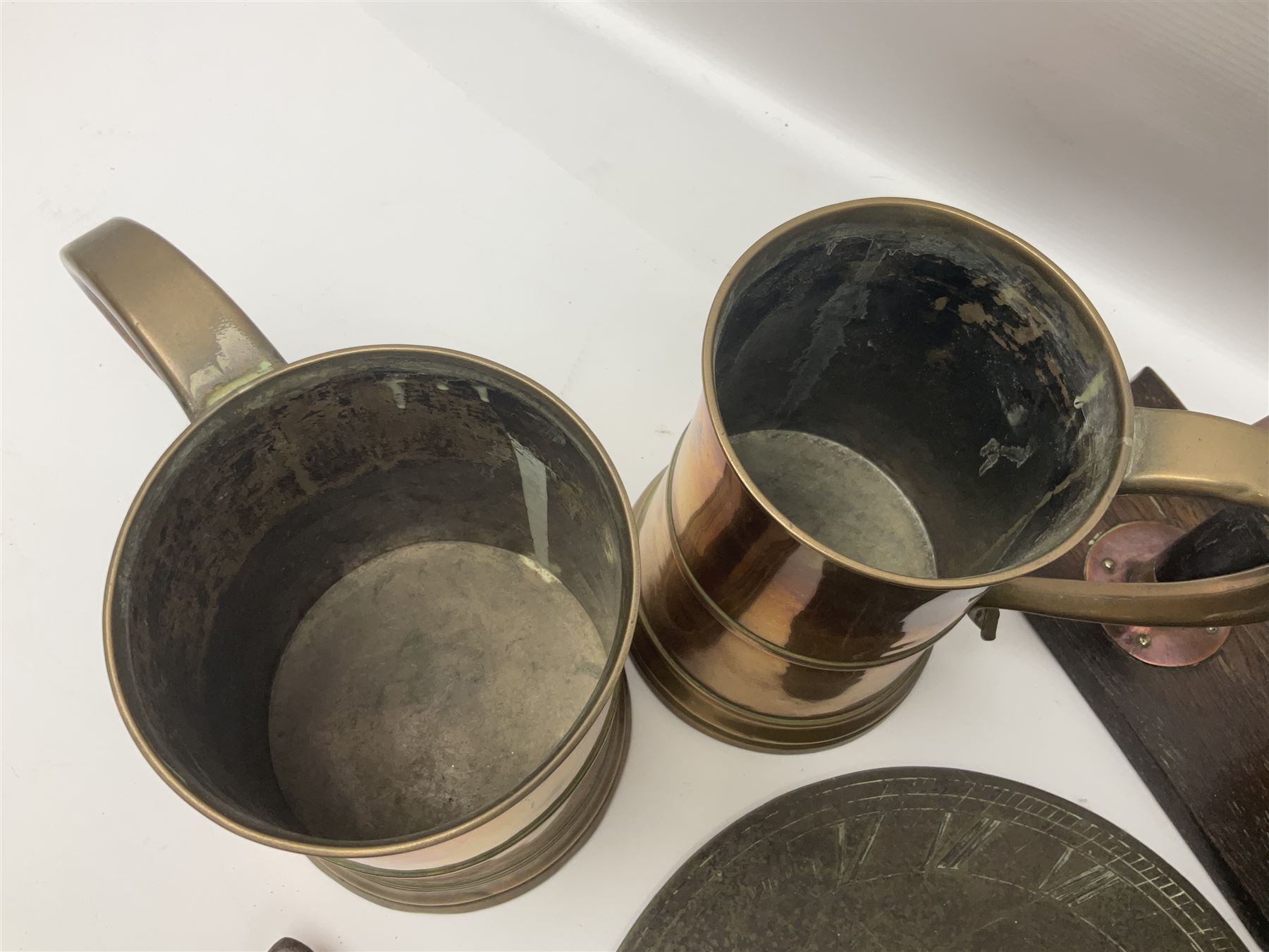 Two 19th century copper tankards, one with weighted wooden base, together with copper and wooden mechanical bellows, sundial and other metalware 