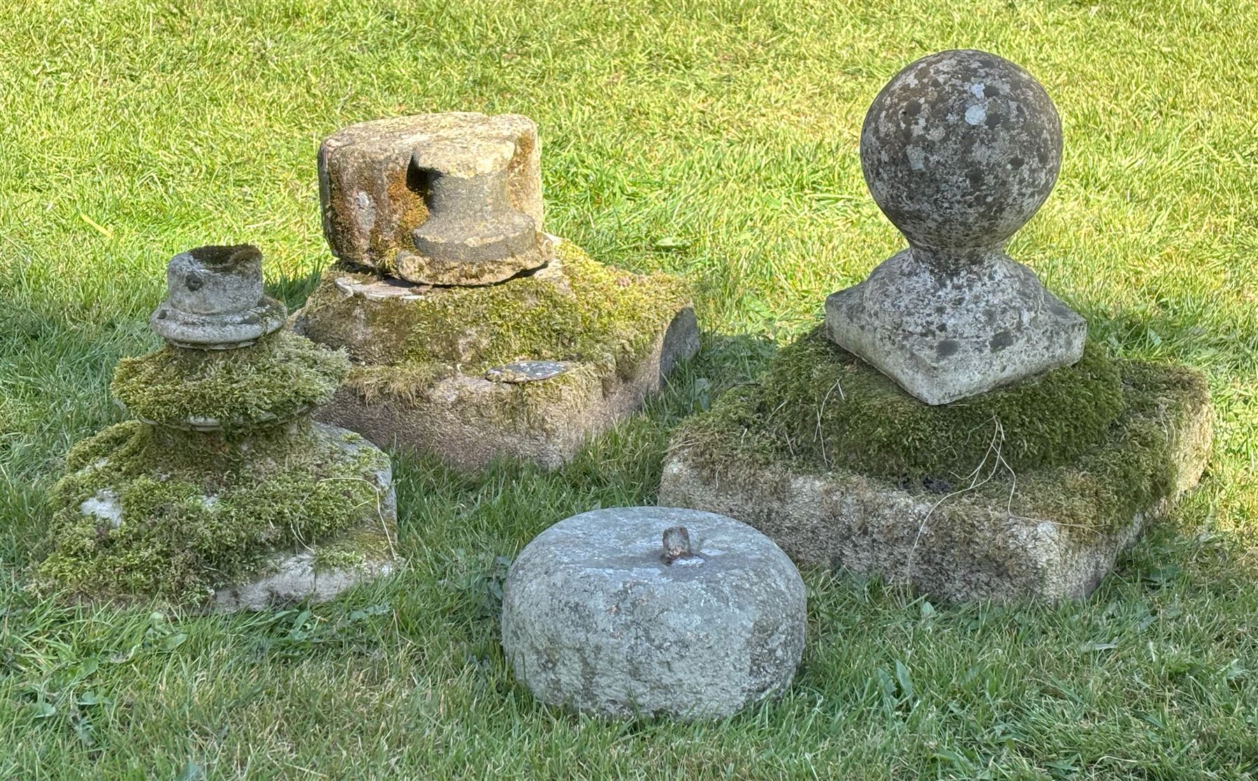 Group of architectural fragments and decorative stone, including a Scottish granite curling stone, a pier cap, composition socles, column bases etc. (6) - COLLECTION BY APPOINTMENT FROM: The White House, Thirsk Road, Easingwold, York, YO61 3NF - CALL 01723 507111 TO ARRANGE