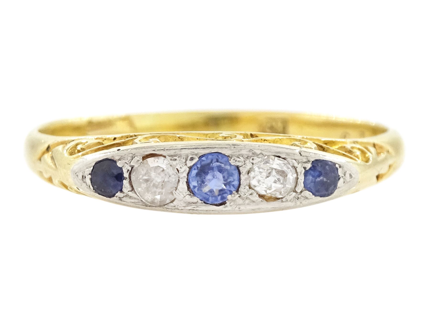 Early 20th century 18ct gold sapphire and diamond five stone ring, set with three round cut sapphires and two old cut diamonds and scroll engraved gallery 