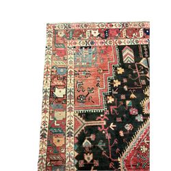 Persian Hamadan rug, the field decorated all-over with stylised plant and flower head motifs, lozenge pole medallion, repeating triple band border 
