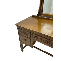 Mid-20th century Jacobean design medium oak dressing table, raised swing mirror over five drawers 