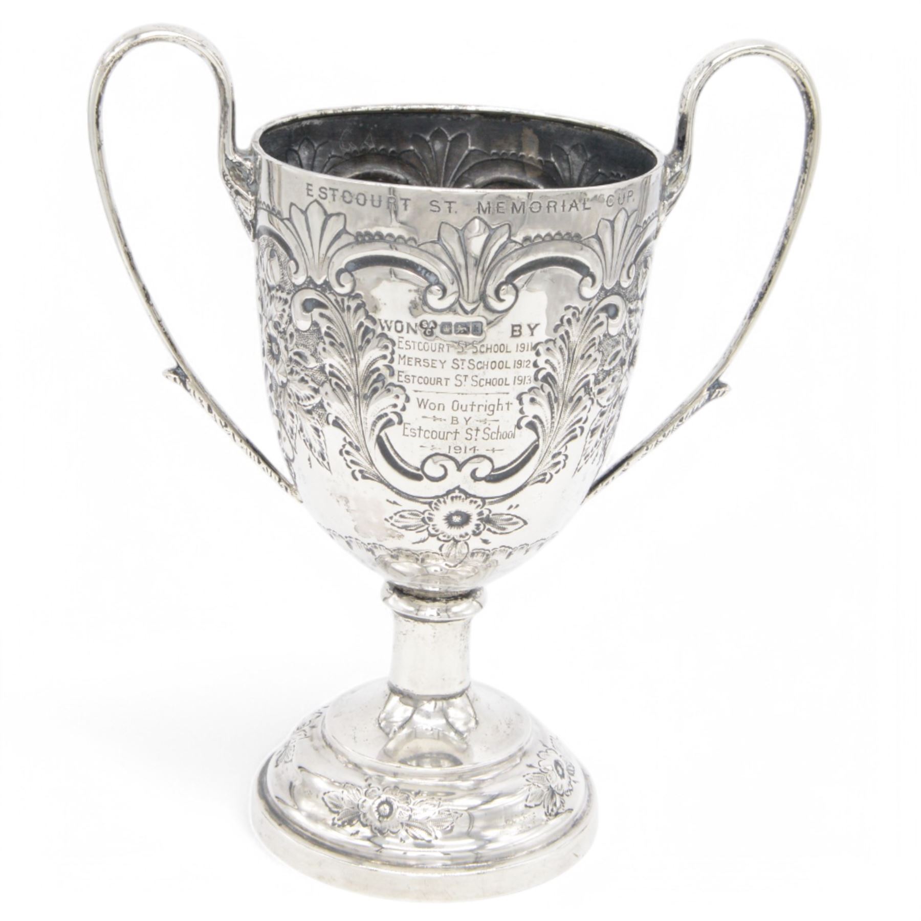 Edwardian silver twin handled trophy, engraved with presentation engraving and embossed with floral and foliate decoration to body, upon a domed circular weighted base, hallmarked 	Hammond, Creake & Co (Saint Arnaud Creake), Sheffield 1902, H22cm