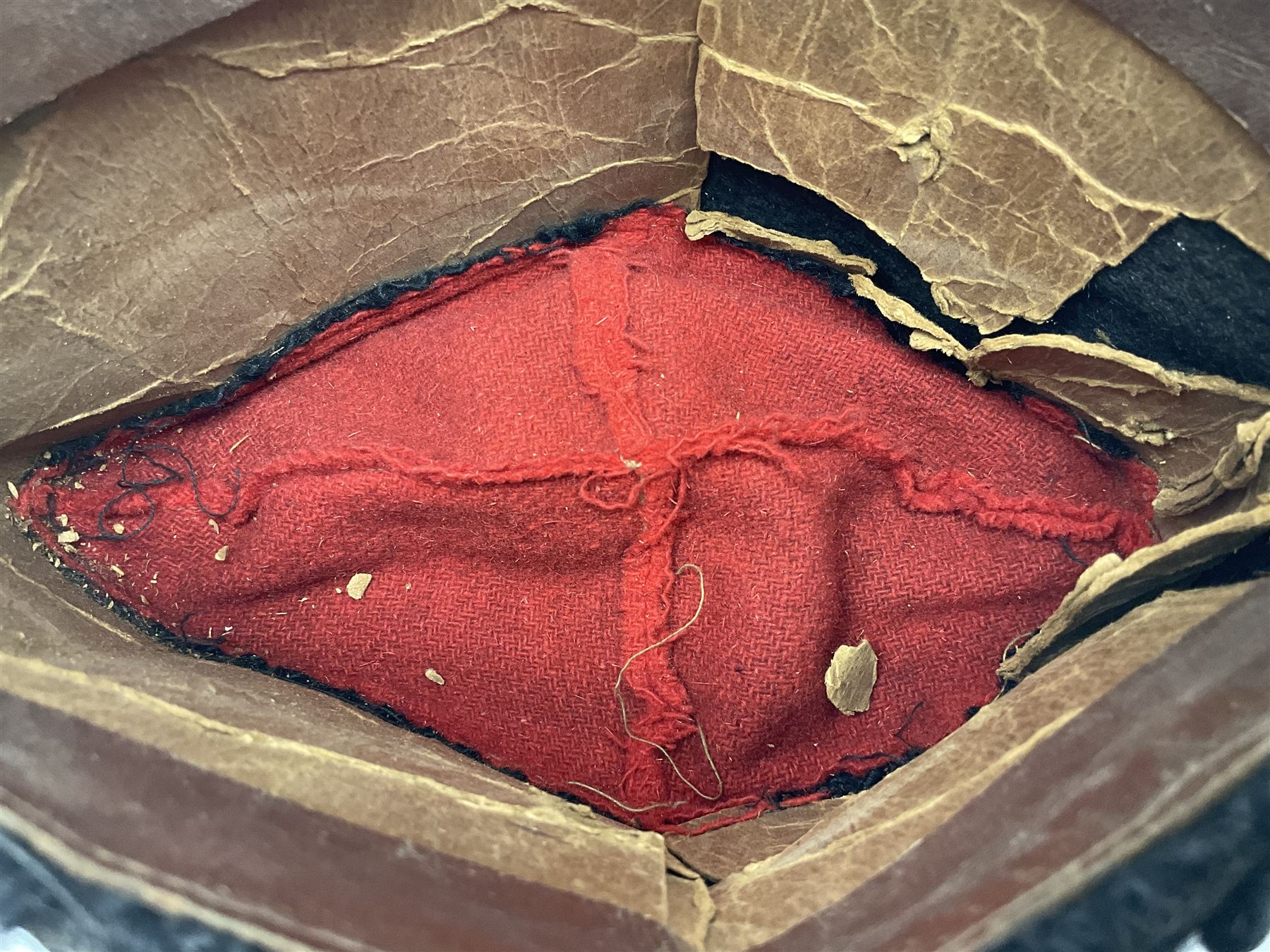 WW2 German small size Balkan style hat with 'SS' metal badges; red cloth top and flash to front with black persianelle type sides; lined in brown card with leather sweatband