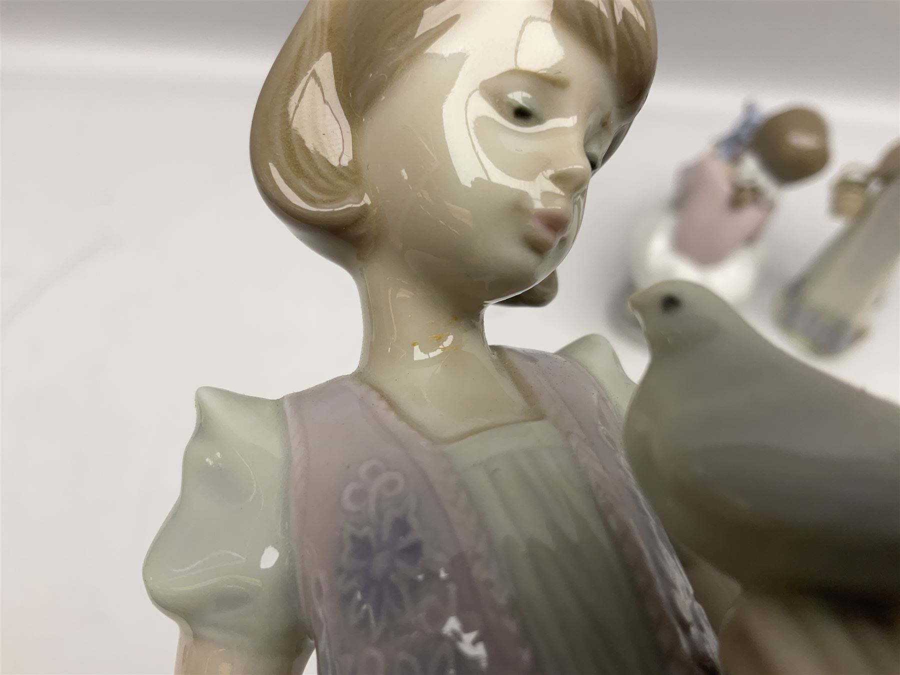 Three Lladro figures, comprising Garden Classic, signed no 7617, Summer Stroll no 7611 and Best Friend no 7620, all with original boxes, largest example H24cm 