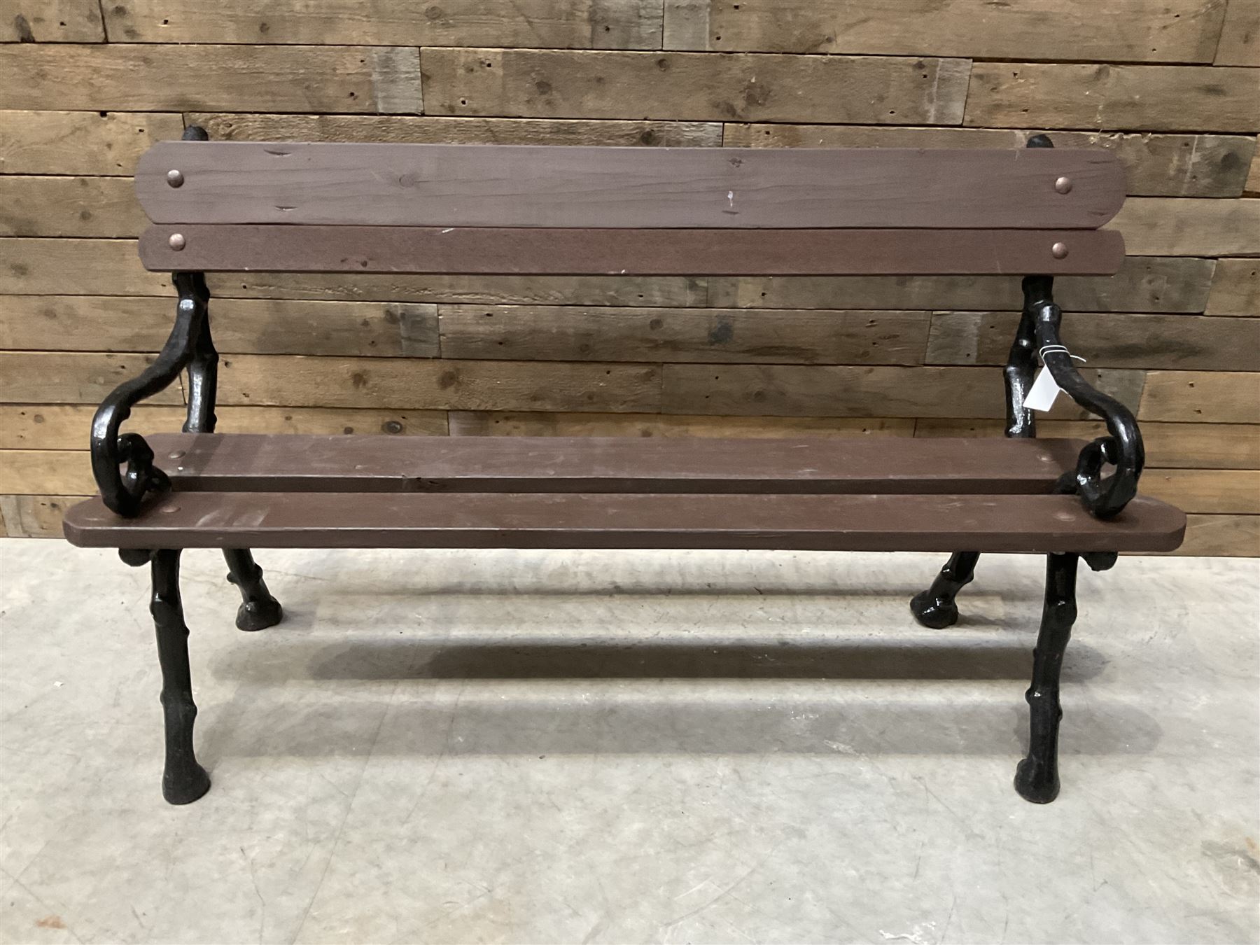 20th century tree cast iron and timber slatted garden bench, black painted frame with stained wood