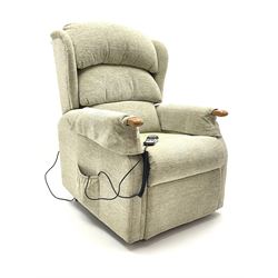 Electric rise and recline armchair upholstered in a light green fabric 