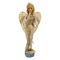 Anna Meszaros Hungary - hand made needlework figurine of an Angel with metallic lace full length dress and open threadwork wings; on moulded base H45cm Auctioneer's Note: Anna Meszaros came to England from her native Hungary in 1959 to marry an English businessman she met while demonstrating her art at the 1958 Brussels Exhibition. Shortly before she left for England she was awarded the title of Folk Artist Master by the Hungarian Government. Anna was a gifted painter of mainly portraits and sculptress before starting to make her figurines which are completely hand made and unique, each with a character and expression of its own. The hands, feet and face are sculptured by layering the material and pulling the features into place with needle and thread. She died in Hull in 1998.
