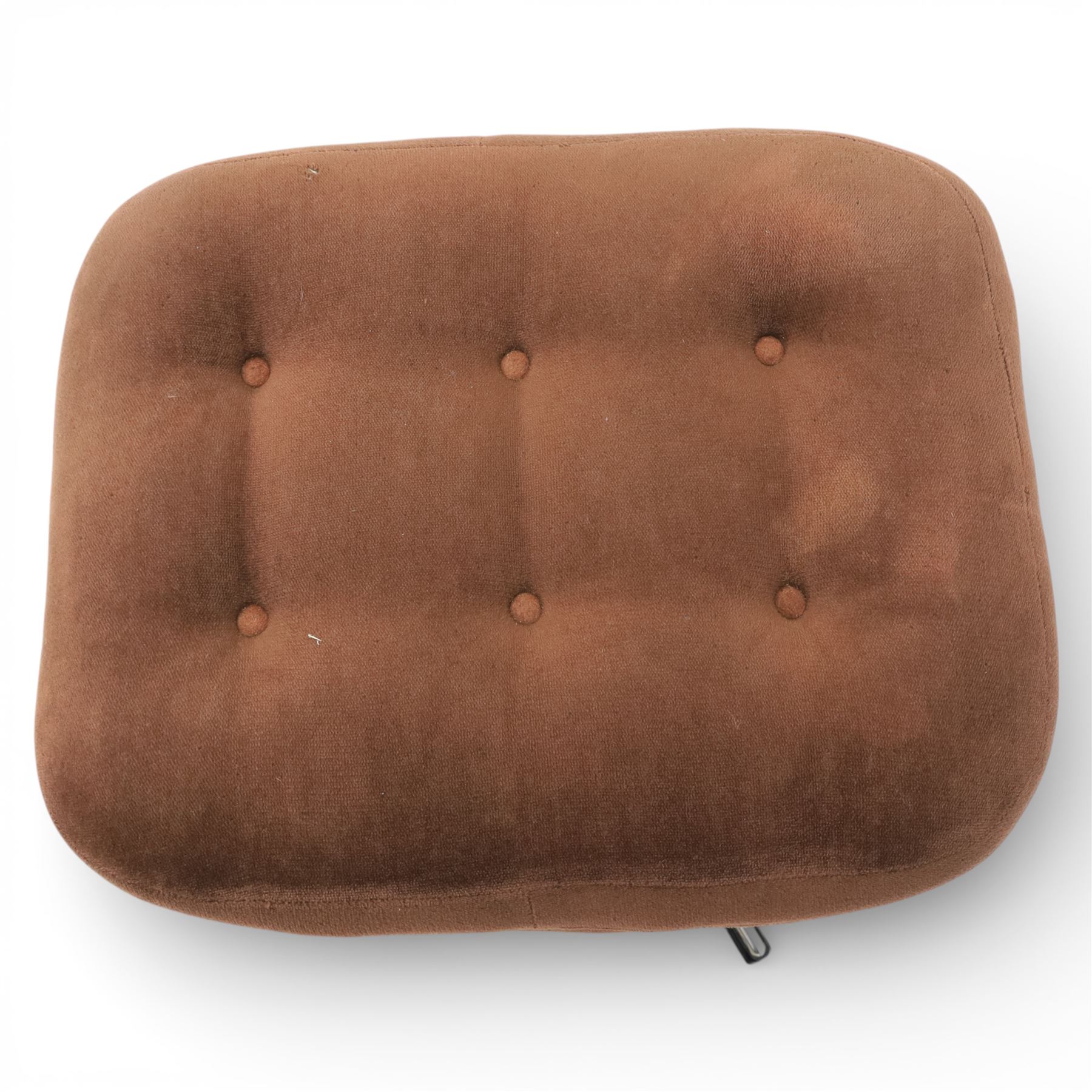 Pair of mid 20th century brown velvet swivel lounge chairs and matching footstool, the shaped and padded back with buttoned segmented cushion over conforming seat cushion, flared armrests and moulded sides, raised on a five point metal swivel base, the footstool en suite with buttoned cushion and matching metal base