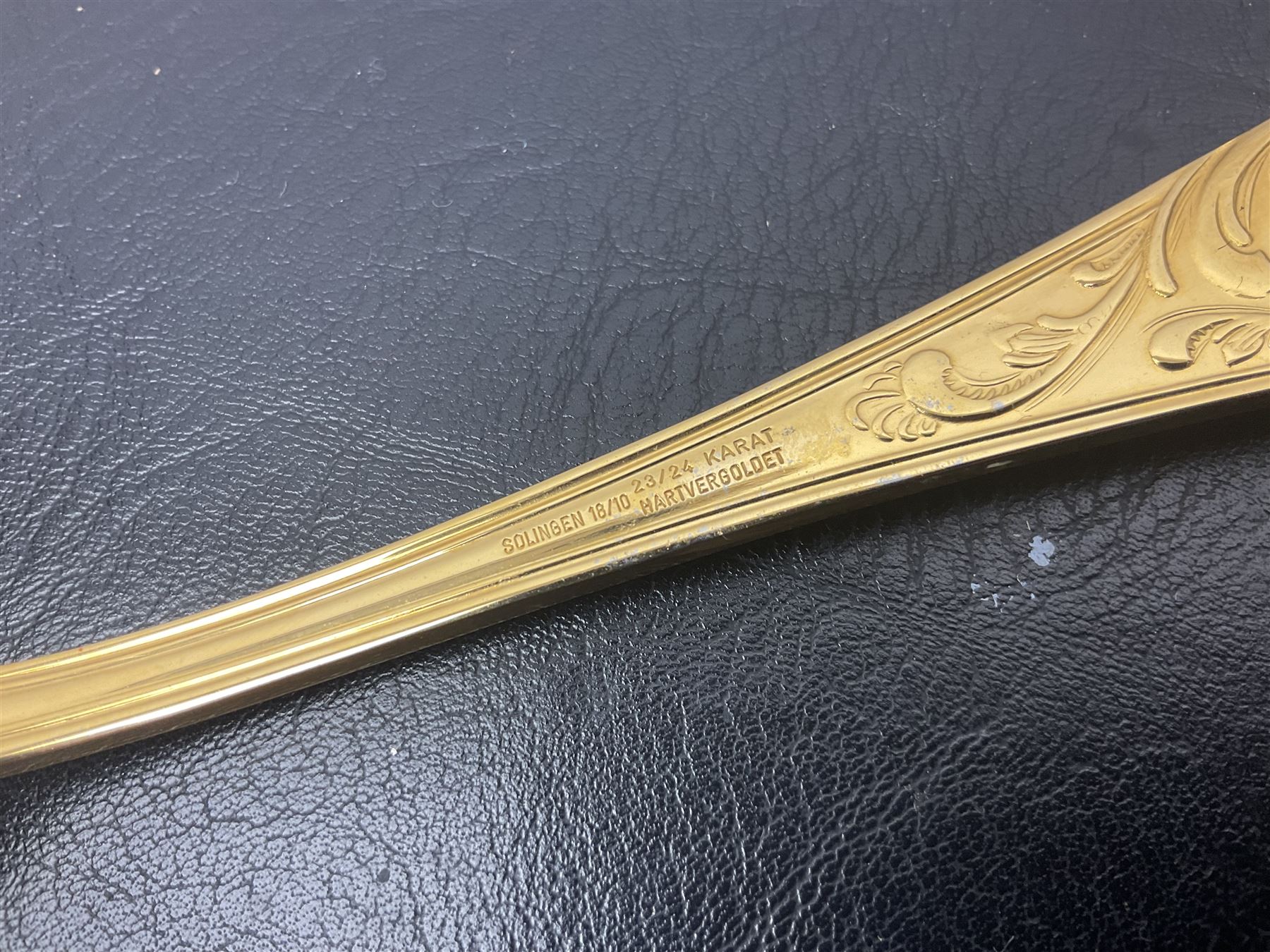 Bestecke Solingen canteen of gold plated cutlery for twelve place settings, including ladle, cake slice and serving spoons, contained within a briefcase, together with a matching set twelve of Bestecke Solingen gold plated fish knives and forks, in fitted case 