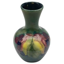 Moorcroft vase, decorated in the Leaf and Berries pattern upon a tonal green ground, together with a further Moorcroft vase, of squat baluster form, decorated in the Iris pattern upon a tonal green ground, each with impressed marks beneath, each H9cm. 