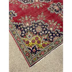 Persian red ground rug, large floral medallion and matching spandrels, decorated with stylised flower heads
