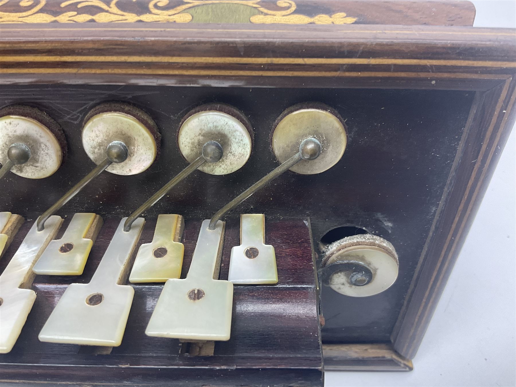 19th Century inlaid rosewood Flutina accordion, stamped Busson of Paris, having sixteen mother of pearl keys and six fold floral decorated bellows L30cm; in baize lined mahogany box