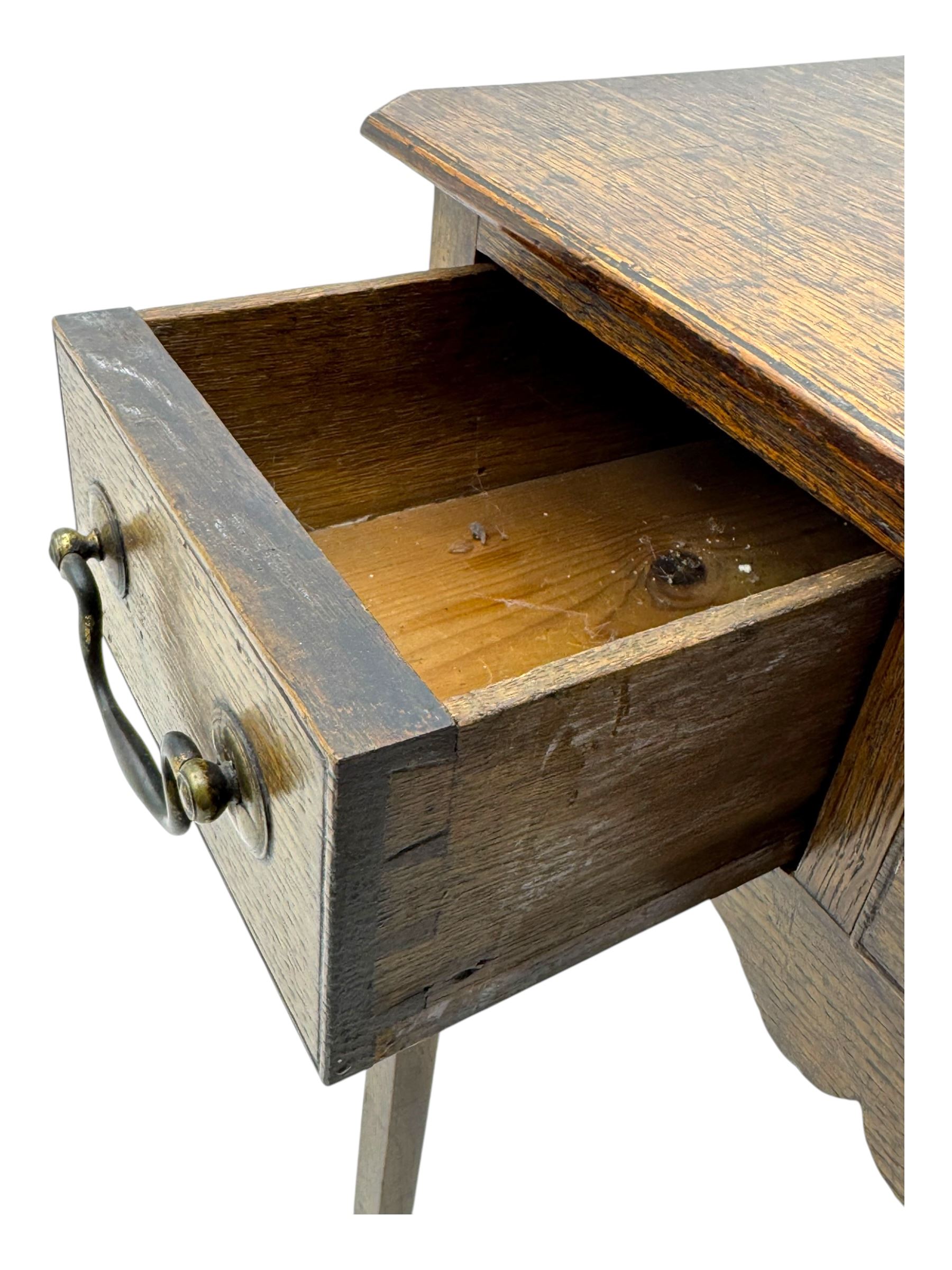18th century oak lowboy, rectangular moulded top over three frieze drawers with brass swing handles, scalloped apron, on slender square section supports