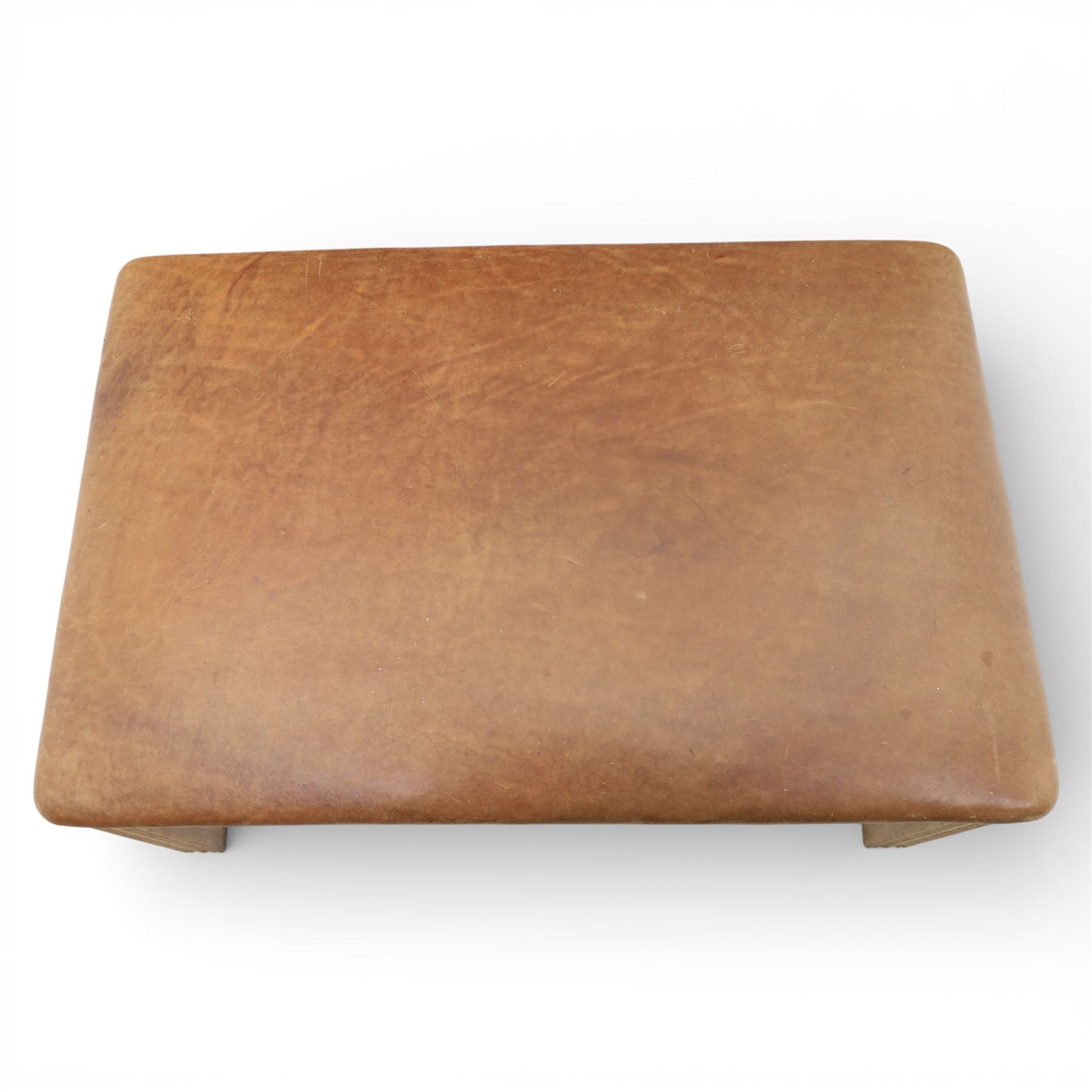 Modern tan leather stool, with studded detailing above a reeded stile supports terminating in metal caps