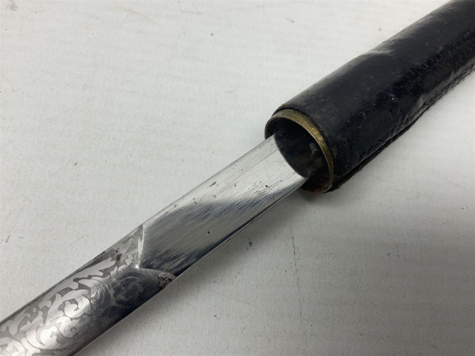Early 20th century British Army Officer’s leather covered swagger / sword stick by Swaine & Adeney of 185 Piccadilly London; 34.5cm double edged spear point blade with etched foliate decoration and retailer’s details; stamped 'Forged in London' to the edge of the ricasso; L59.5cm overall