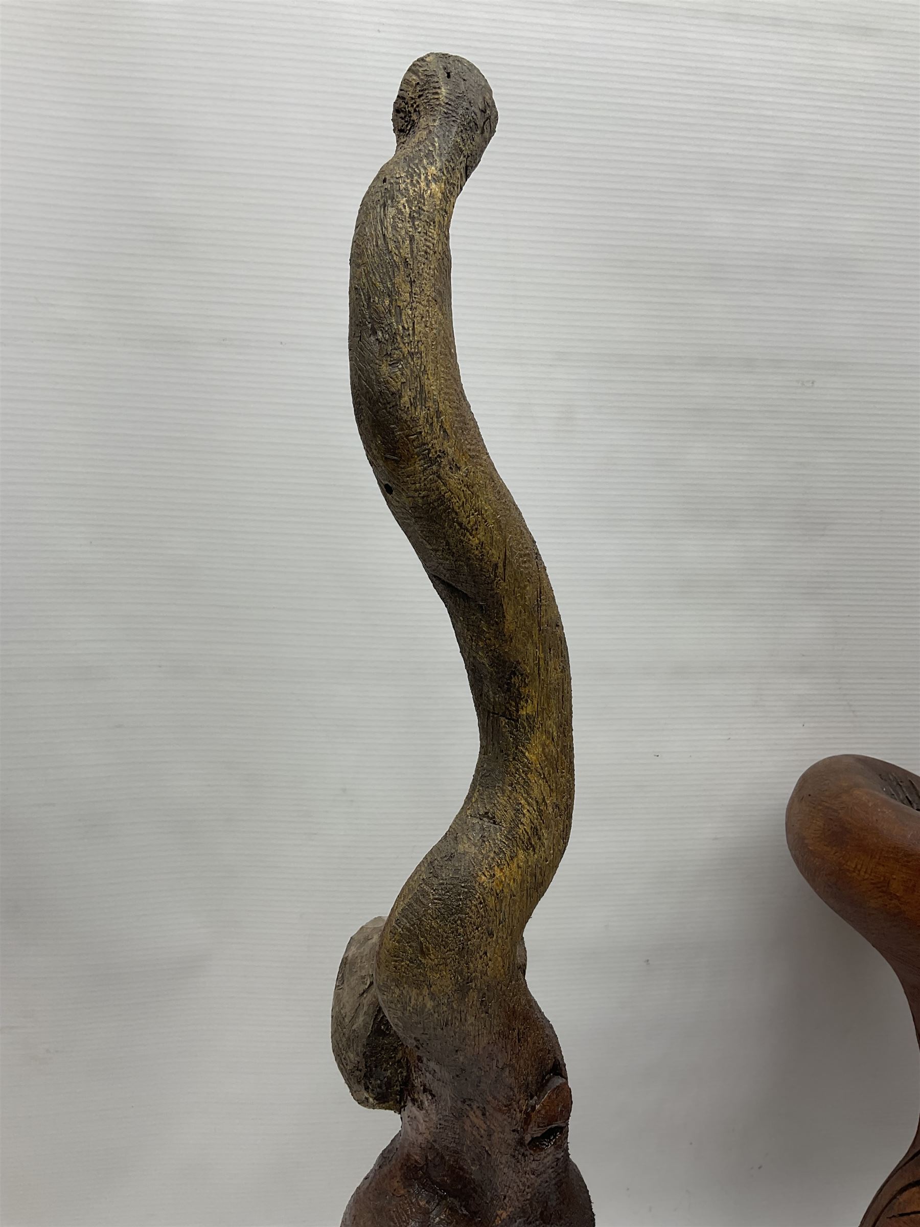 Helen Skelton (British 1933 – 2023): Three carved wooden abstract sculptures, each modelled as a cat, with carved or painted features, largest H63cm. Born into an RAF family in 1933 in Kent and travelled the world extensively during her childhood. After settling in Bridlington, Helen immersed herself in painting, textiles, and wood sculpture, often inspired by nature's beauty. Her talent was showcased in a one-woman show at Sewerby Hall and recognised with the sculpture prize at Ferens Art Gallery in 2000. Sadly, Helen’s daughter passed away from cancer in 2005. This loss inspired Helen to donate her sculptures to Marie Curie upon her passing in 2023.