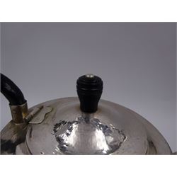 Modern Arts and Crafts style silver teapot, of circular faceted form, with hammered finish and ebonised wooden handle and finial, upon circular domed foot, hallmarked John Henry Pank, London 1994, with Hull town mark, H17cm