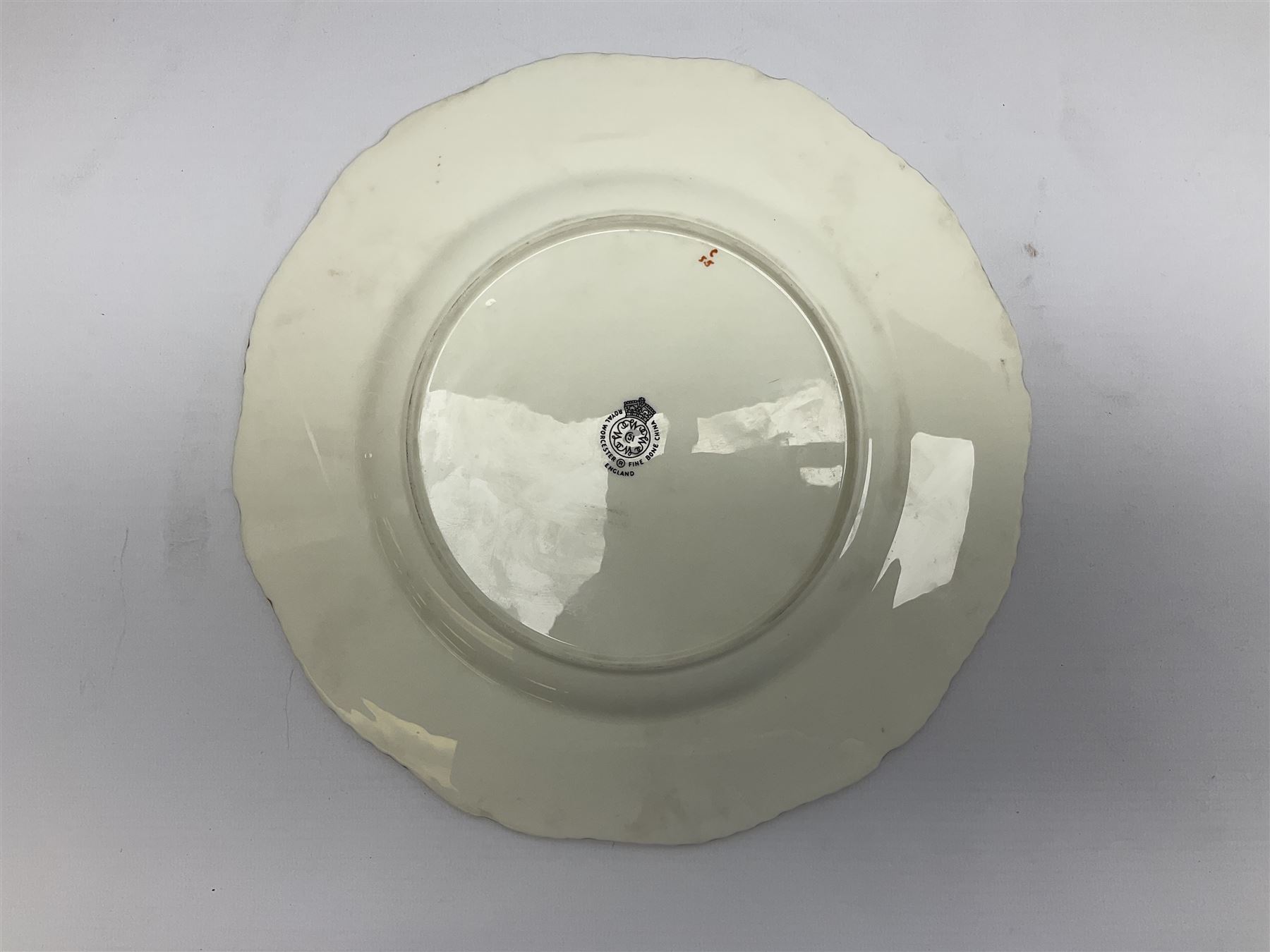 Mid 20th century Royal Worcester cabinet plate decorated by John Freeman, of circular form with gilt shaped rim, hand painted with a still life of fruit upon a mossy ground, signed Freeman, with black printed mark beneath, D27cm