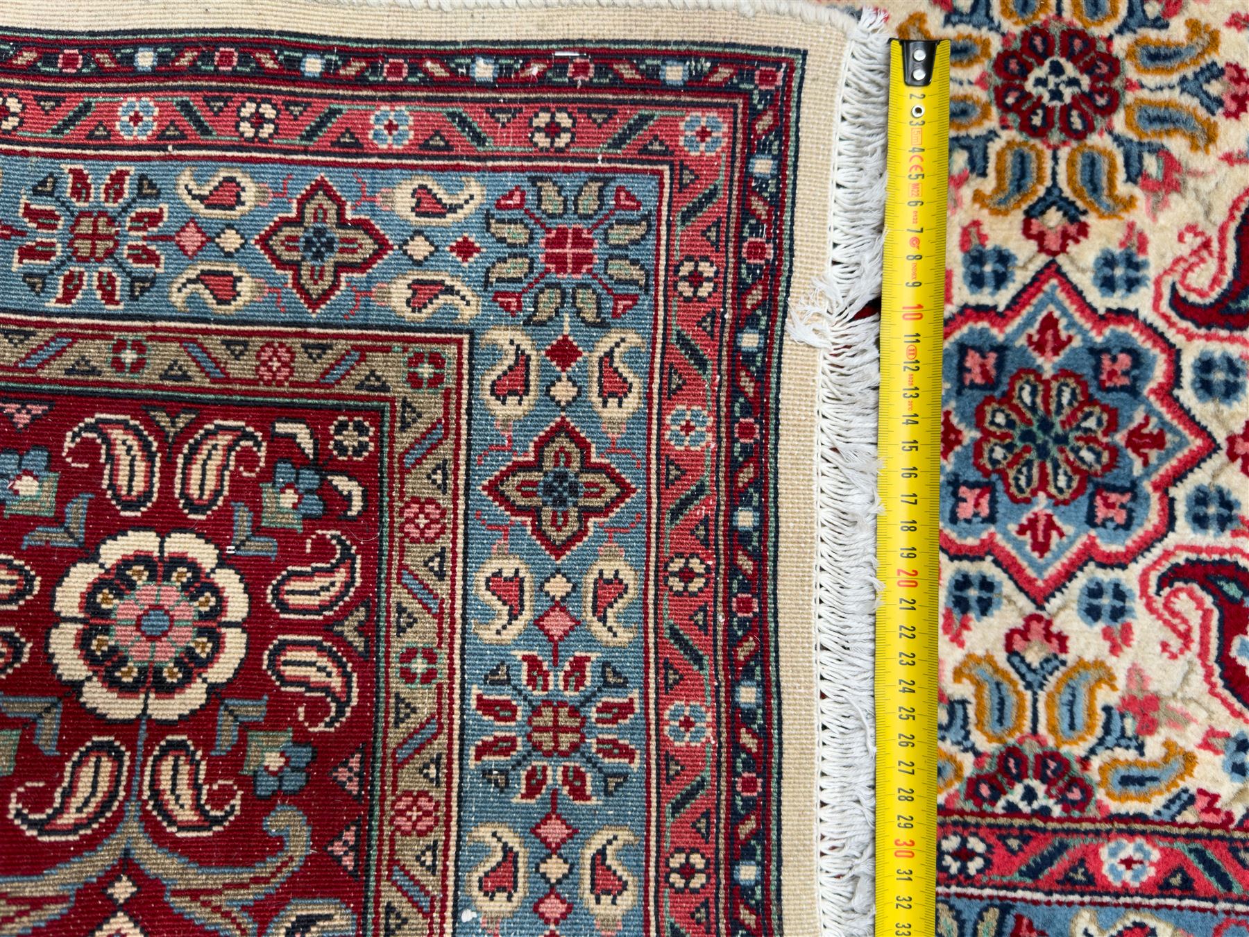 Northwestern Persian Hamadan carpet, hand-knotted, ivory field with an all-over Herati design of rosettes and serrated leaves within multiple borders, madder red with angular vine and rosette motifs, 375cm x 271cm 