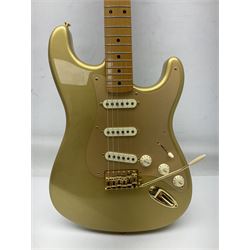 Fender Stratocaster 50th Anniversary 2004 metallic gold electric guitar; serial no.MZ4116369; L98cm; in Spider fitted case with owners manual and other paperwork, strap and belt buckle etc