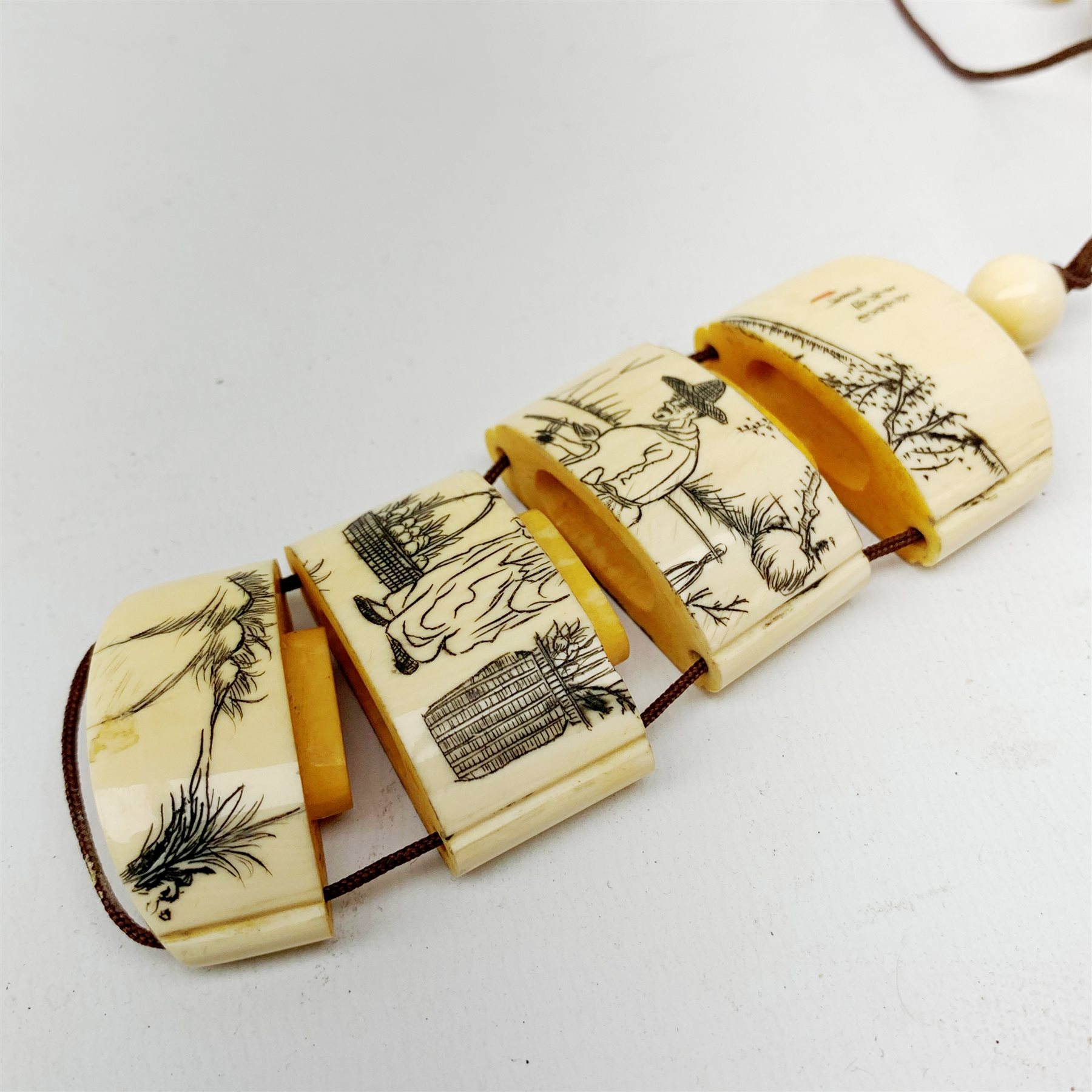 Japanese Meiji ivory four case inro, decorated with a figure of a farmer, and tiger to reverse, signed, L8cm  