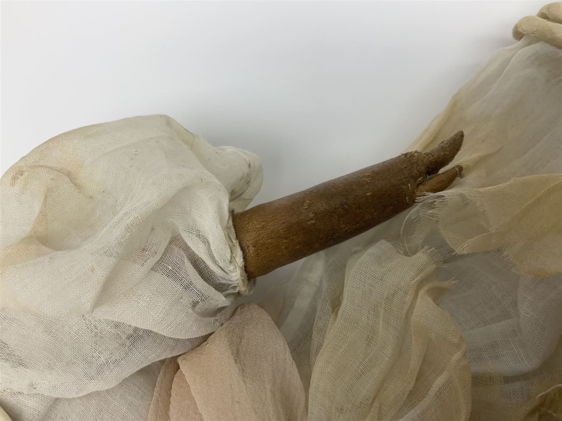 Victorian wax shoulder head doll with pale complexion, applied hair, inset glass eyes and fabric covered jointed body with kid leather lower arms; white linen dress and undergarments H50cm