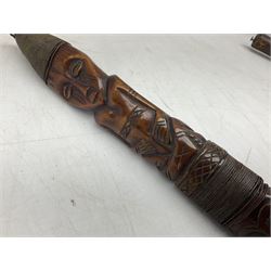 Tribal Art - an African axe, possibly Yoruba, the bone shaft carved as two cord bound stylised figures with iron fan-shaped blade, L35cm overall; and 19th century harpoon or spear head of square section with two long fixing arms on cut-down ash shaft L57cm (2)