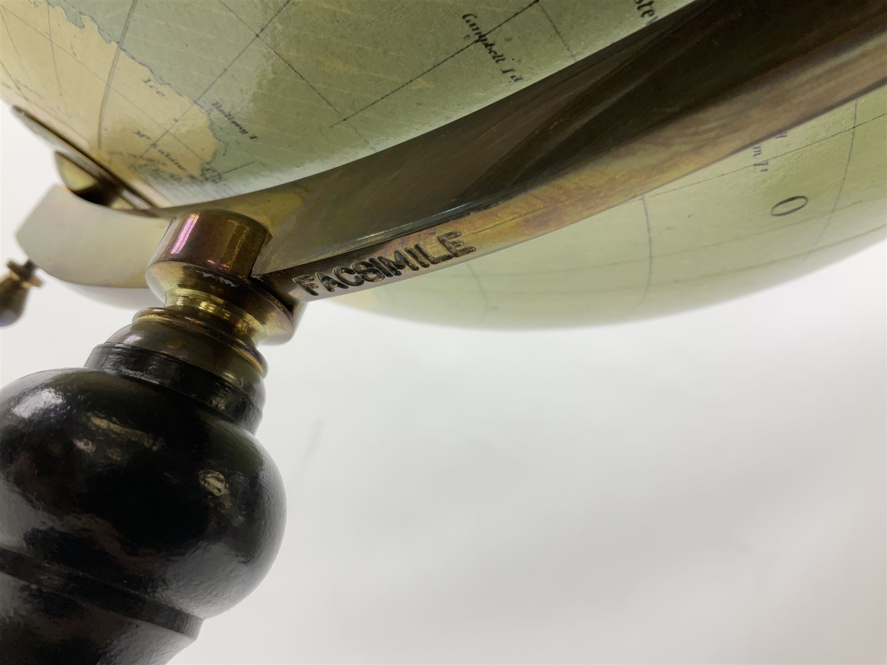 Terrestrial globe by Grinell, Washington, mounted on a brass half meridian and raised on turned wood pedestal base, H55cm