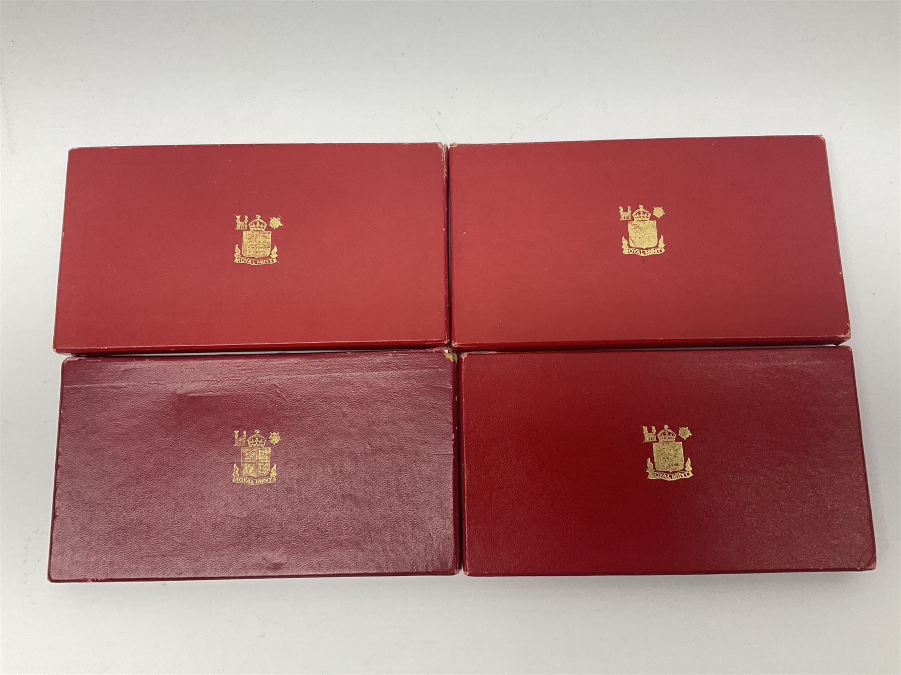 Four King George VI 1950 specimen coin sets, each comprising farthing, half penny, penny, threepence, sixpence, English  one shilling, Scottish one shilling, two shillings and half crown, each in red Royal Mint card case