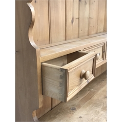 Solid waxed pine dresser, raised two heights plate rack with small drawers, the base fitted with three drawers and three cupboards, W127cm, H206cm, D47cm