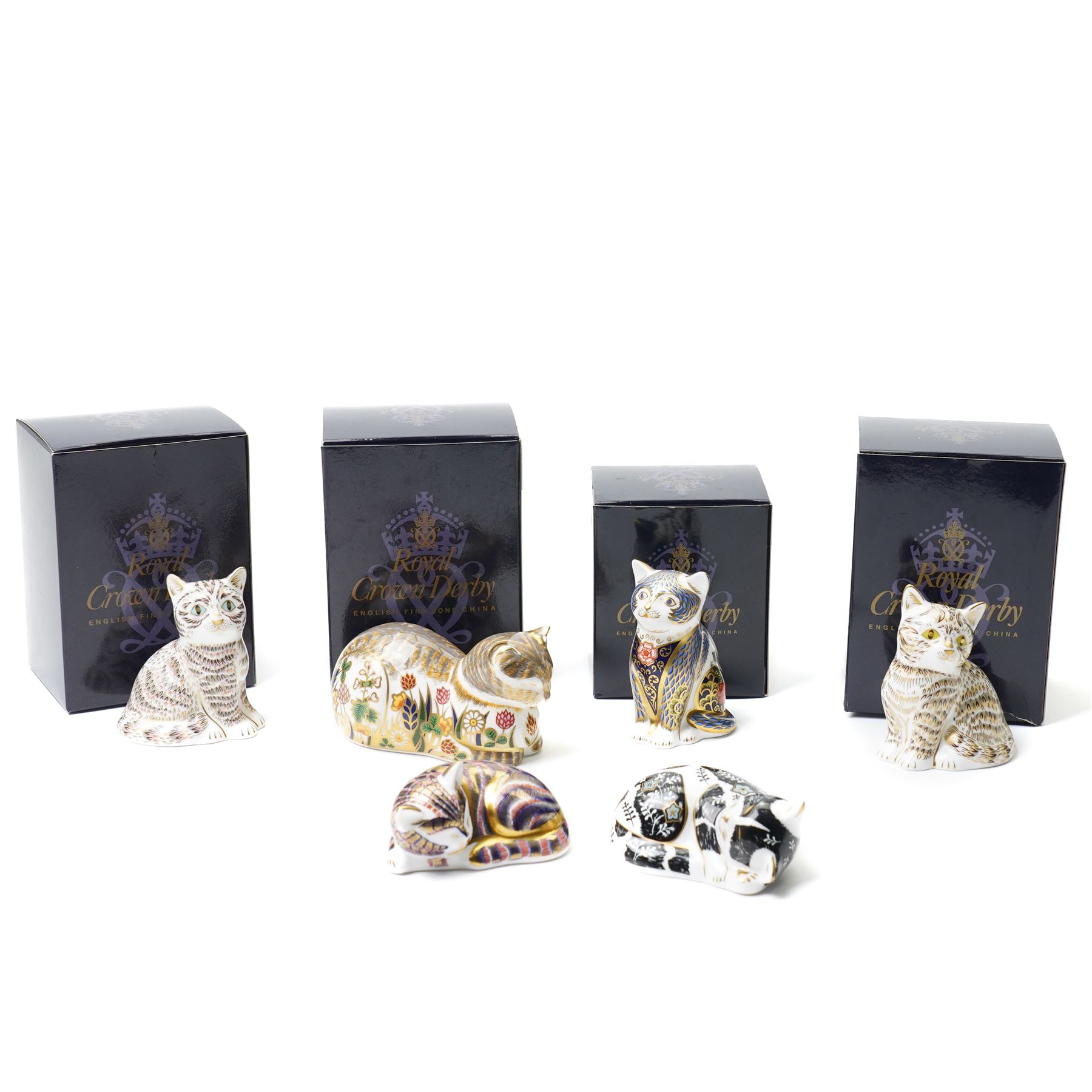 Six Royal Crown Derby paperweights, comprising 'Misty' collectors cat with gold stopper, Sleeping Cat with silver stopper, Fireside Kitten with gold stopper, Thomas Silver Tabby Kitten with gold stopper, Tabitha Silver Tabby Kitten with gold stopper, Cottage Cat with gold stopper, four with boxes (6)