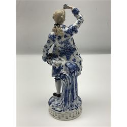 Meissen blue and white figure, modelled as a gentleman holding a hat of flowers, raised upon Greek key design base, with blue crossed swords and impressed C 73 and 149 marks beneath, H18cm