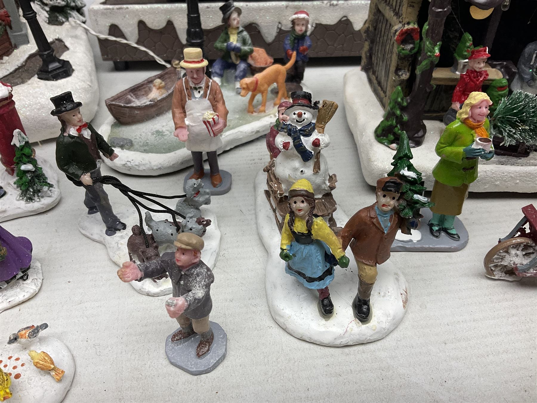 Christmas decorations; Premier LED Christmas Village scene with moving train, together with three Lumineo christmas scenes, and other similar 