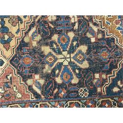Caucasian pale ground rug, the field divided into lozenges each decorated with stylised plant motifs, the guarded border decorated with repeating flower heads 