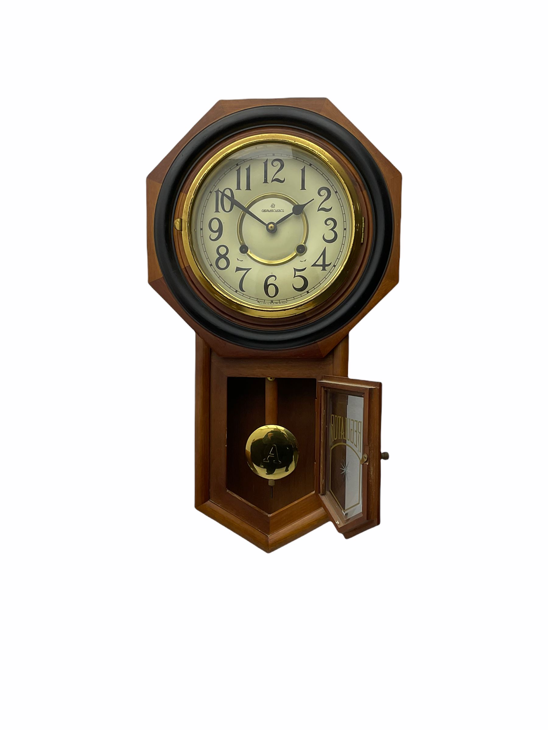Contemporary spring driven wall clock striking the hours on a gong, case with a wooden octagonal dial surround and two piece creme dial with Arabic numerals, steel spade hands, brass effect pendulum bob visible through case door, dial inscribed 