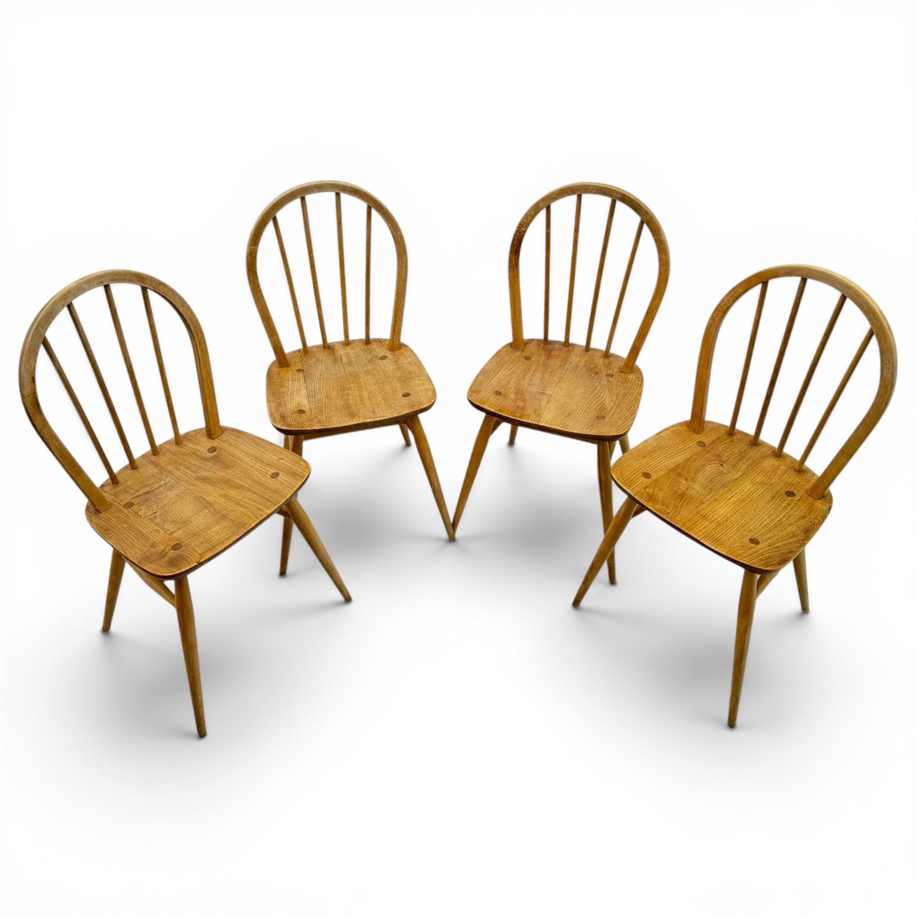 Ercol - set of four elm 'Windsor' chairs, hoop design back dish seat, tapering supports united by H-stretcher 