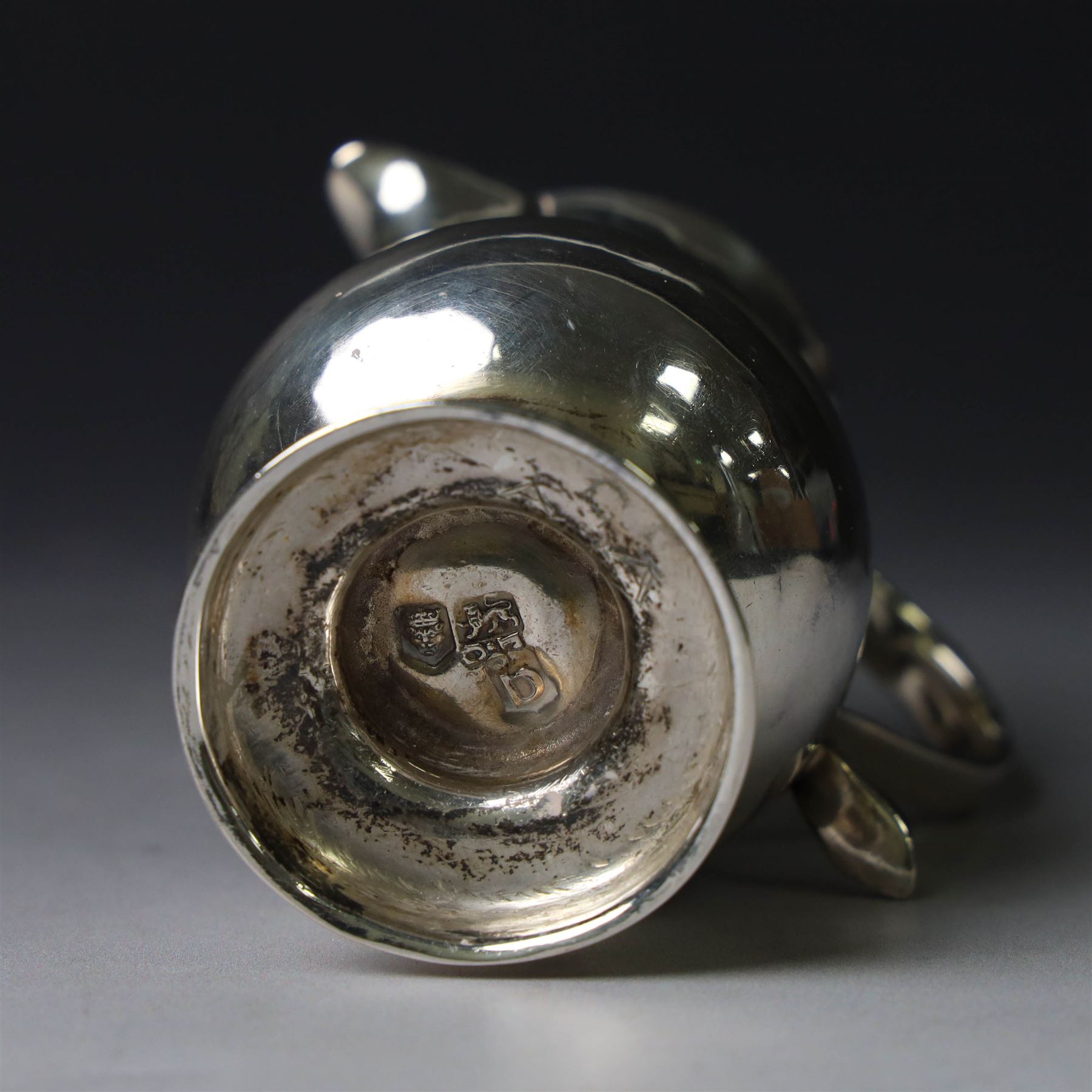 George II silver cream jug, of plain bellied form with capped scroll handle and sparrow beak, upon stepped circular foot, hallmarked London 1737, makers mark indistinct, H8.5cm
