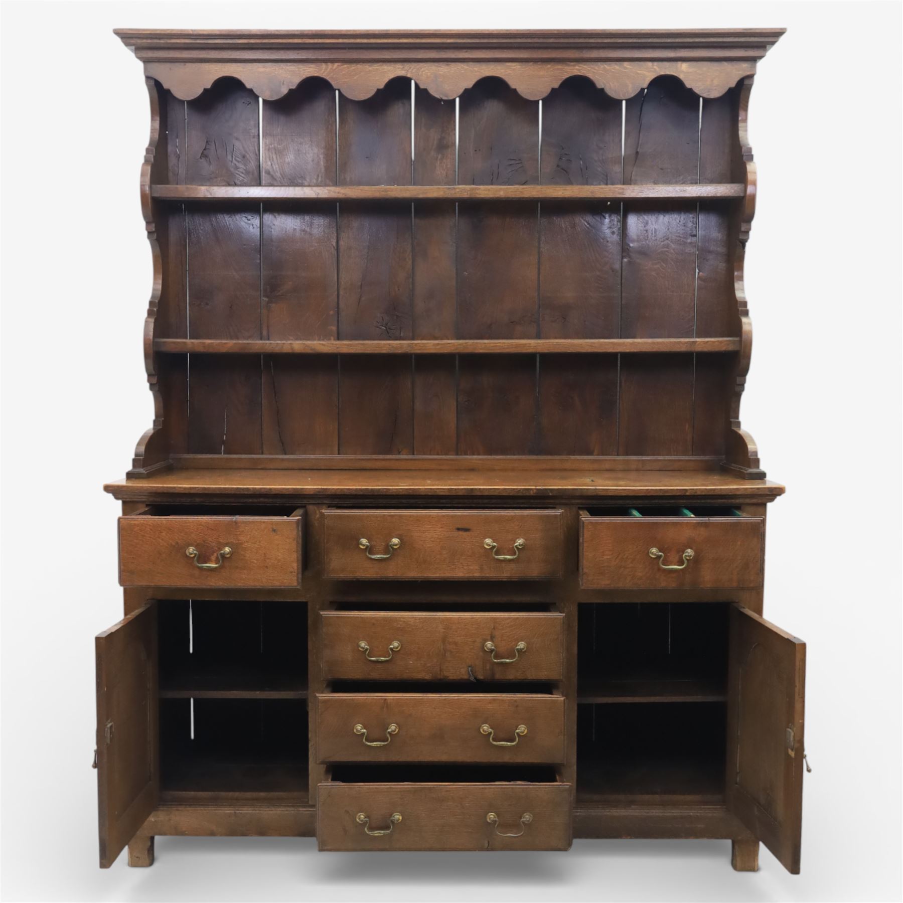 Georgian design oak dresser, the raised plate rack with shaped sides and two open shelves, upon a dresser base fitted with six drawers and two cupboard doors, and short block feet 