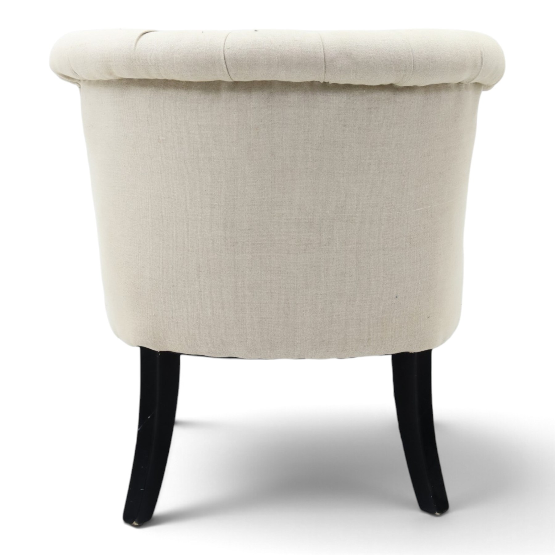 Victorian style upholstered tub chair, buttoned cream fabric back and seat with rolled sides, on ebonised turned front supports with brass castors and splayed rear supports