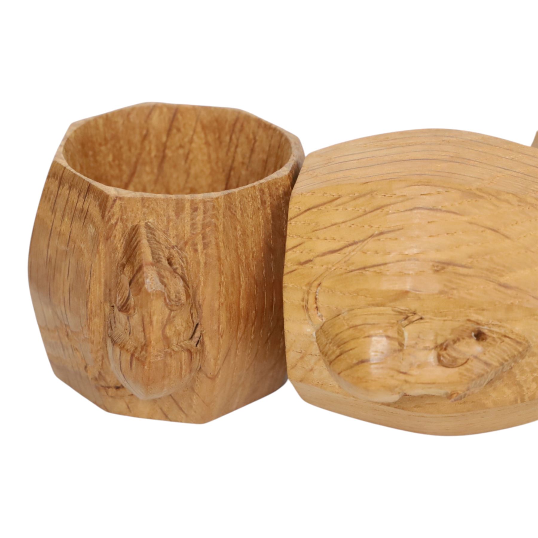 Mouseman - four light oak napkin rings, of bulbous octagonal form with signature mouse carving by Robert Thompson of Kilburn