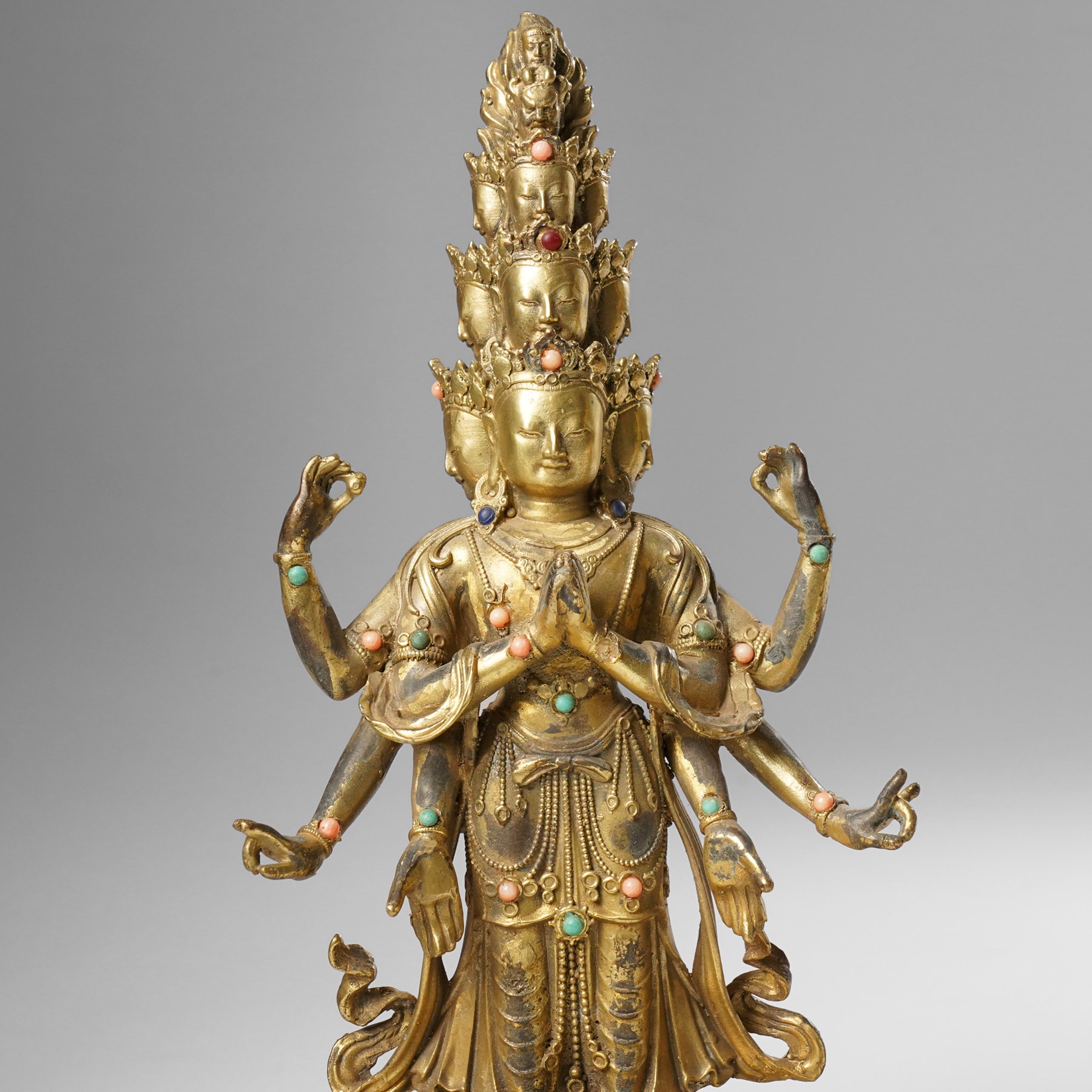 Tibetan gilt bronze figure of Ekadashamukha Avalokiteshvara, standing upright on lotus base, his primary hands in anjali mudra, the other six radiating to the sides, H28cm; together with a gilt bronze figure of Ganesh or Ganapati, H26cm (2)