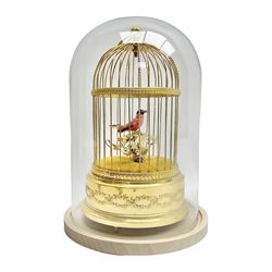 Swiss Reuge Music bird cage automaton music box, the bird with articulated head and beak, in a gilt brass cage, with a glass dome and stand, H30cm